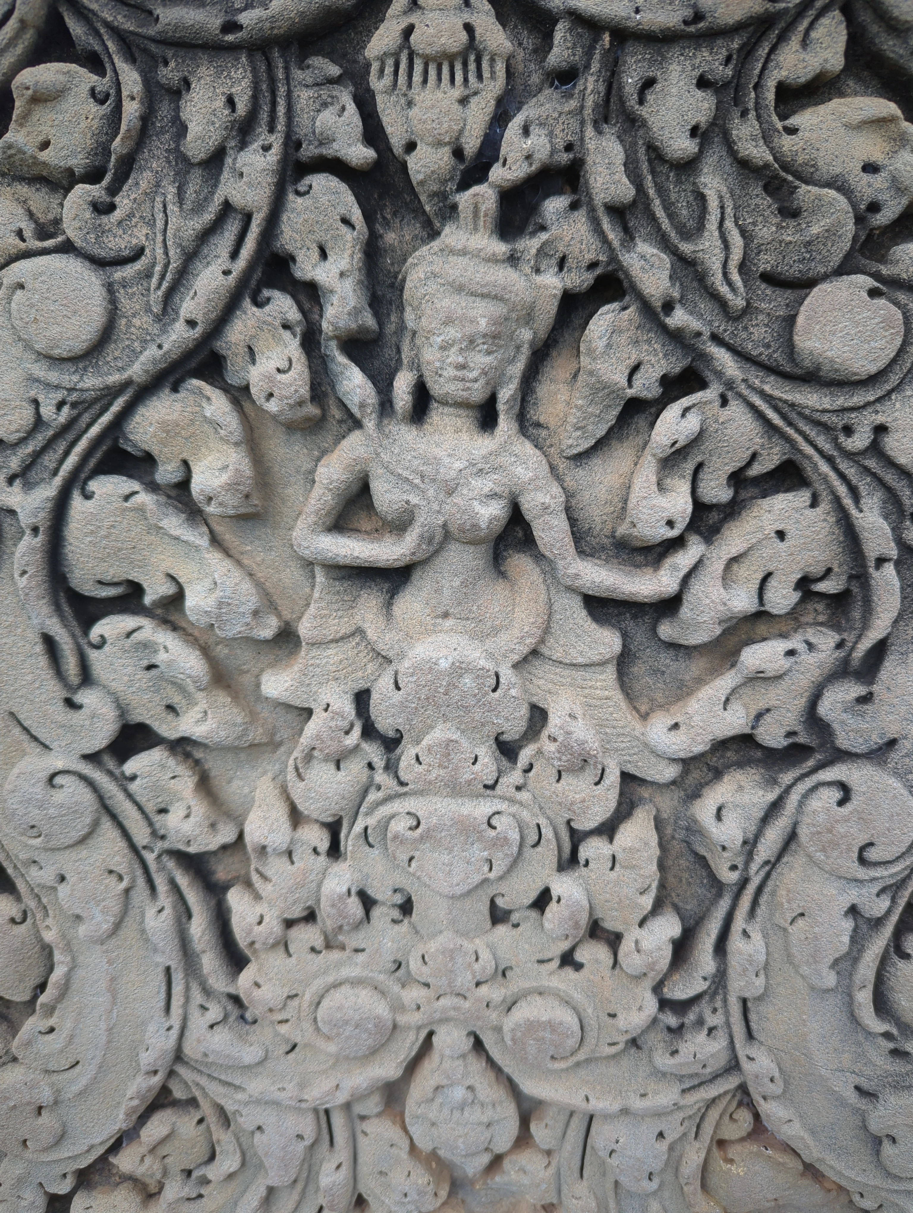 Detailed apsara dancer carving on sandstone wall at Angkor Wat