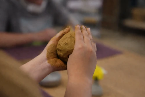 Artisans refine each piece by smoothing surfaces, trimming edges, and carving decorative patterns.